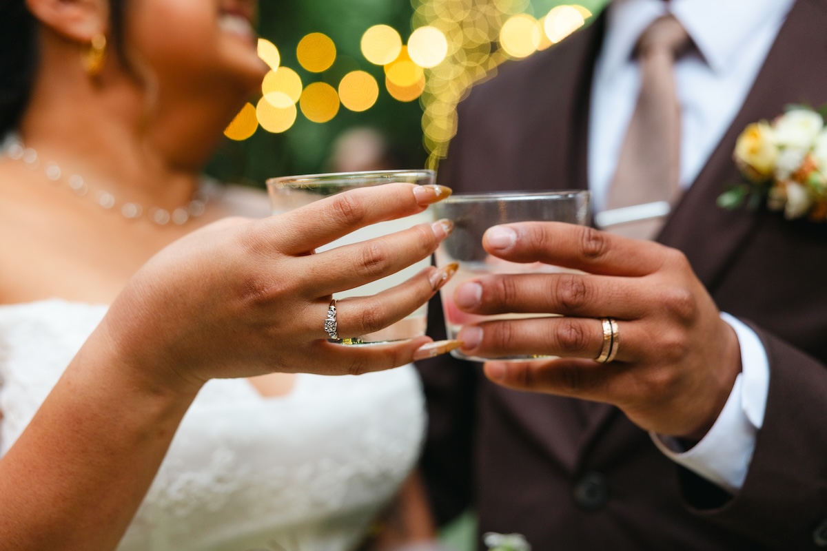 A bride and groom cheers drink at their wedding in Saratoga Springs California.