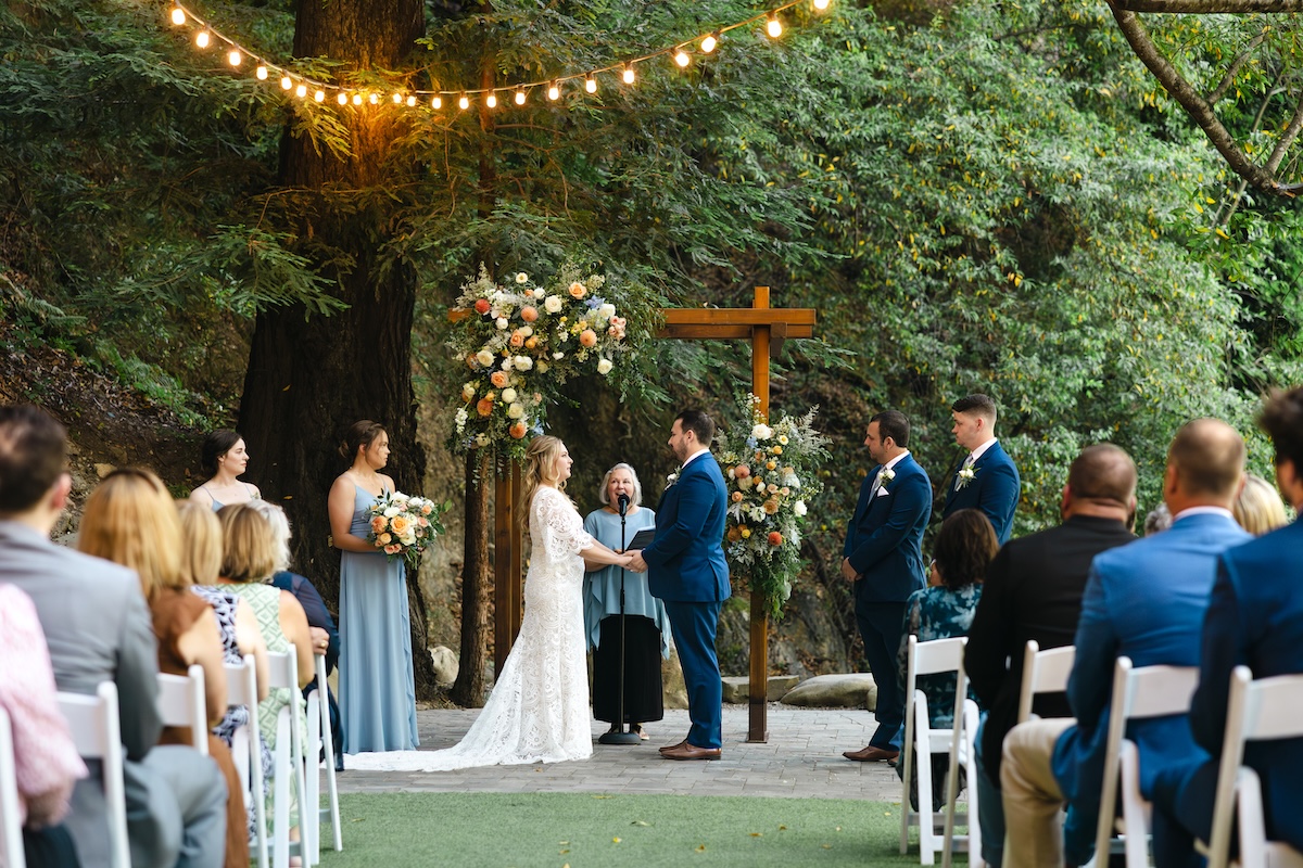 Wedding ceremony in Redwood Grove at Saratoga Springs California. Florals by H&J Flowers.