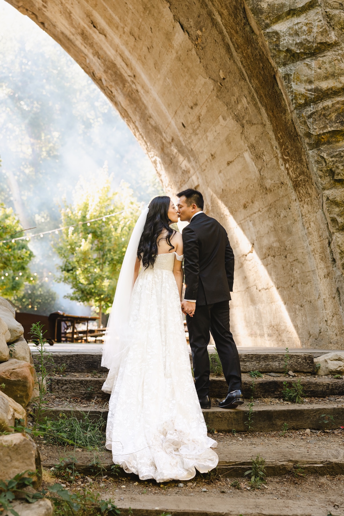 Couple's portraits under Long Bridge in Saratoga Springs California.