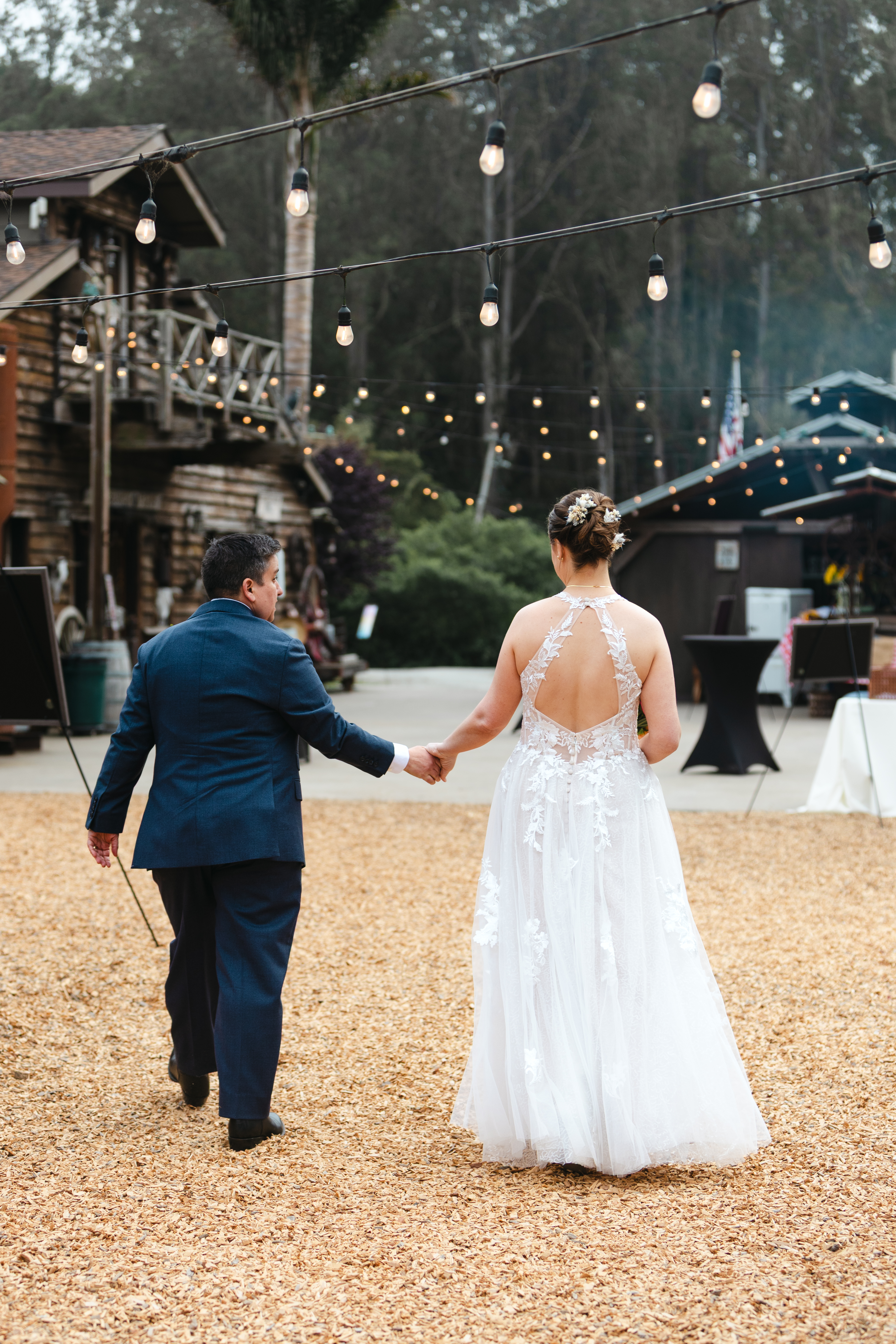 Two brides walk their recessional at their wedding in Half Moon Bay.